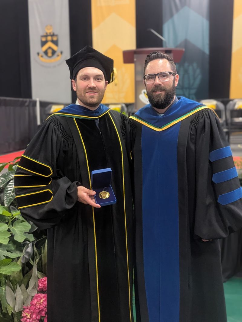 Dr Brendan Bishop accepting the Gold Medal alongside supervisor Prof. Leslie Robbins at Spring 2025 U Regina Convocation