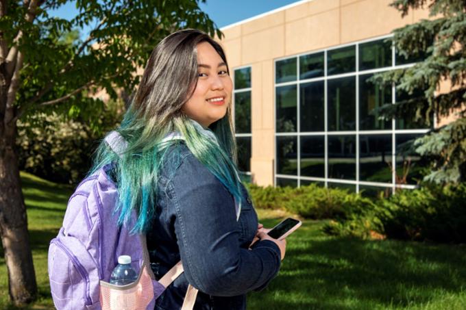 A student looks back over her shoulder while on campus