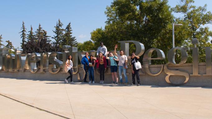 Students in front of the U of R sign