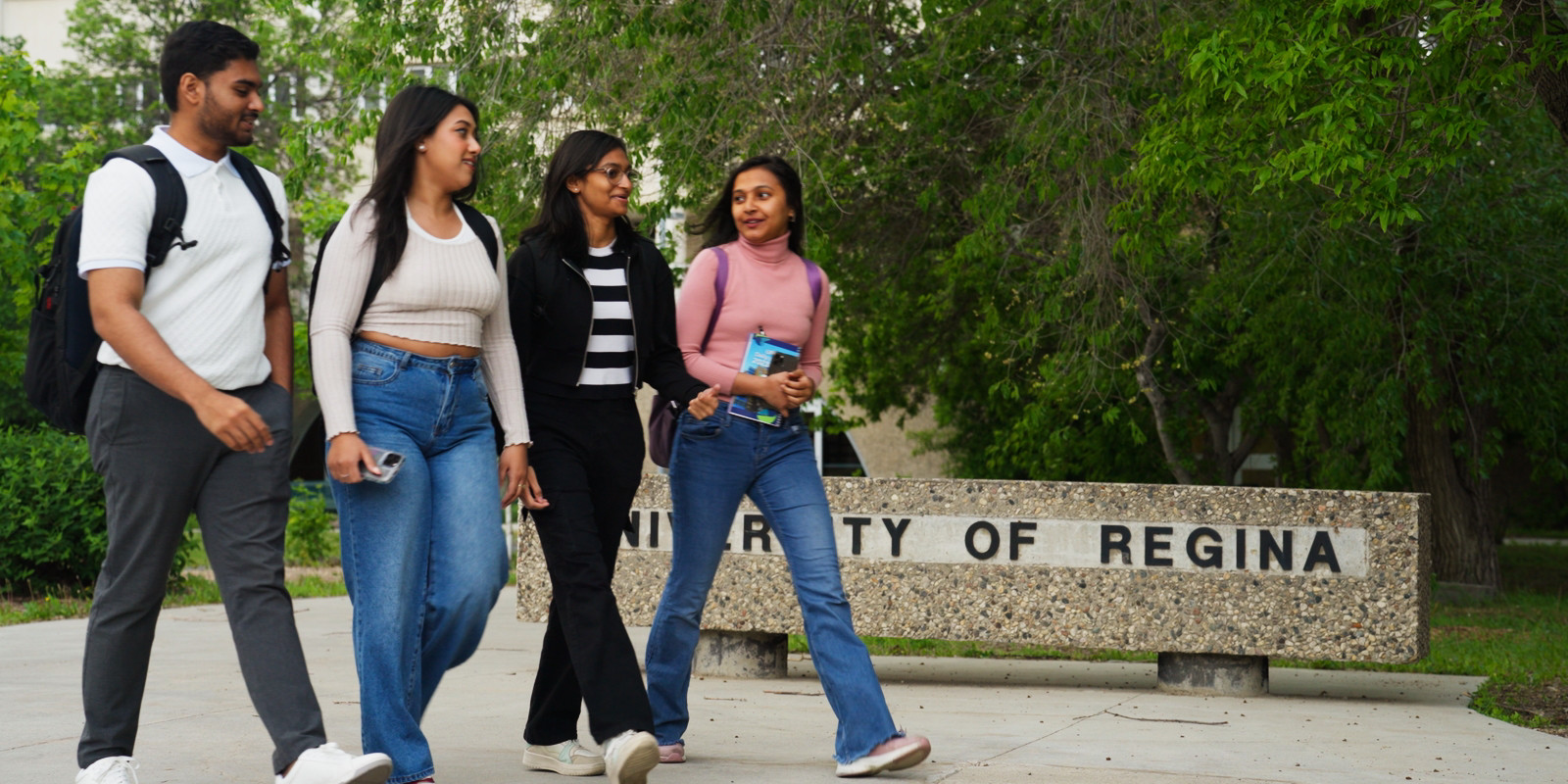 four students walking on campus