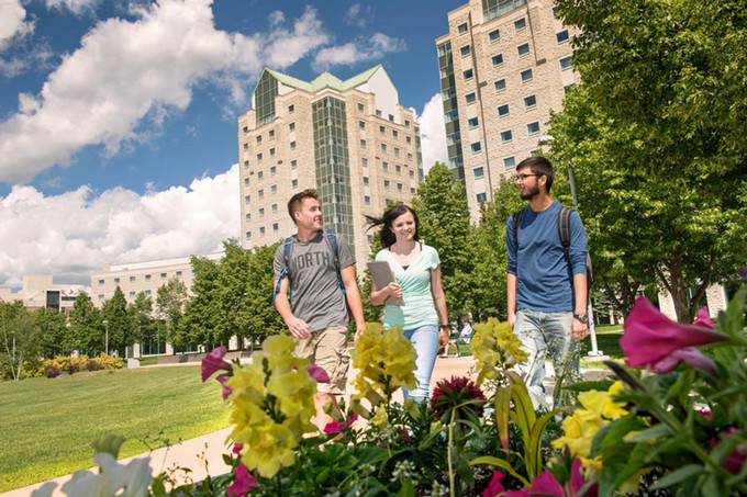 three students outdoors on campus