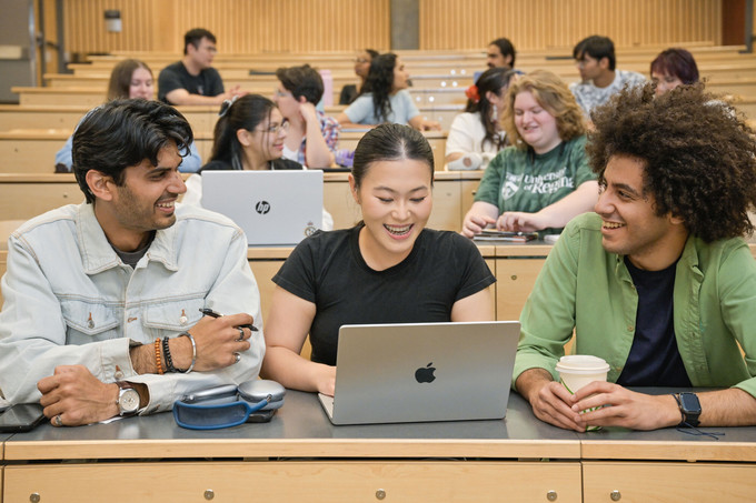 three students in a lecture theatre