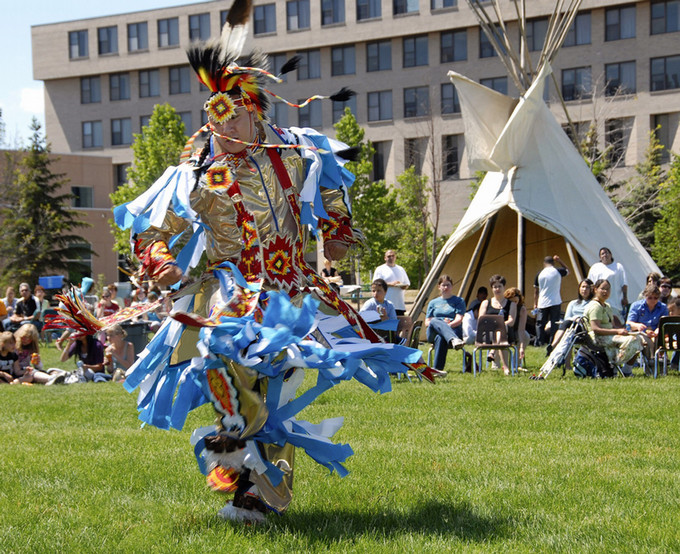 dancer in regalia on campus