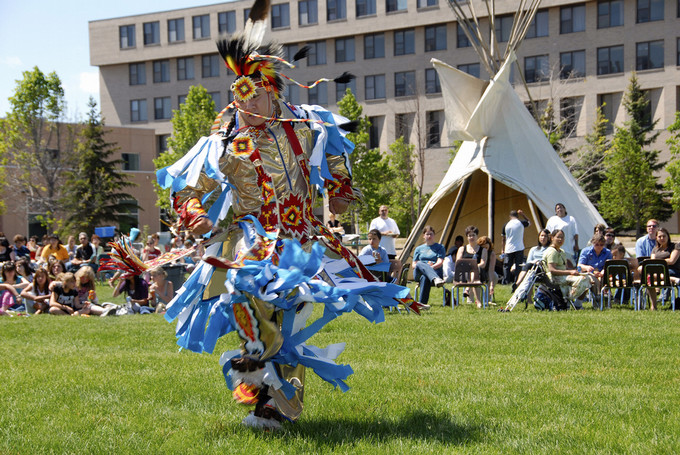 dancer in regalia on campus
