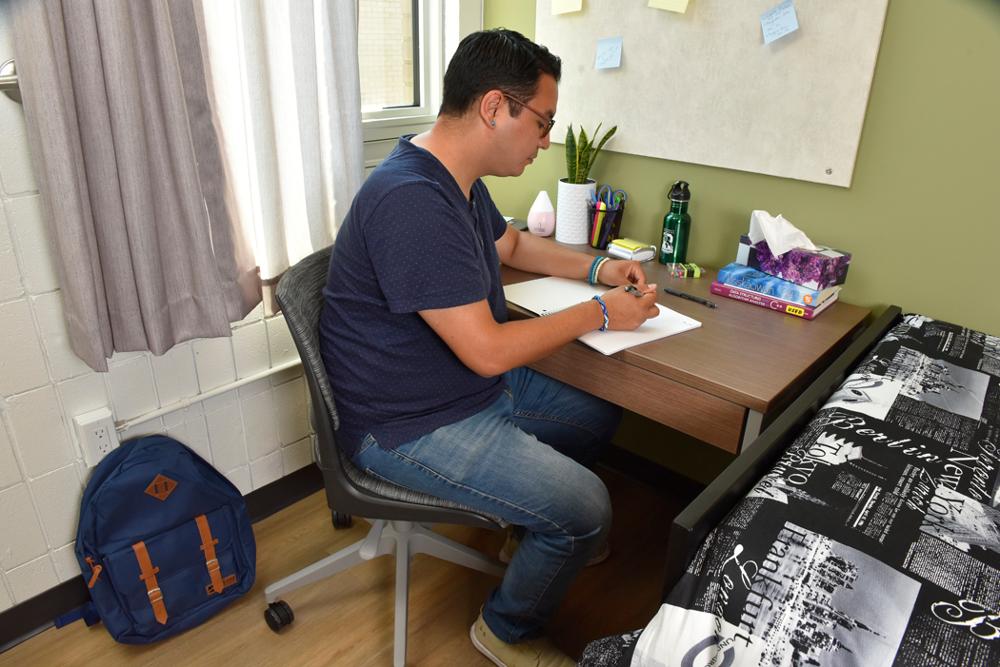 Student studying in a dorm room