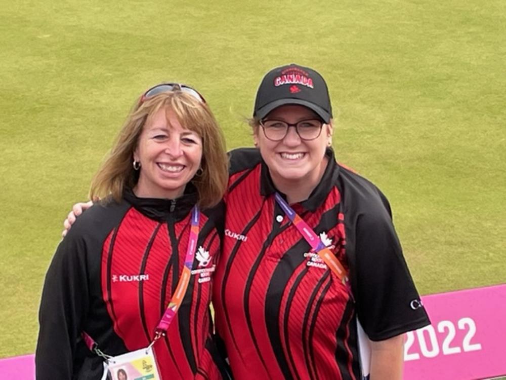 Two women posing for a photo at a lawn bowling tournament