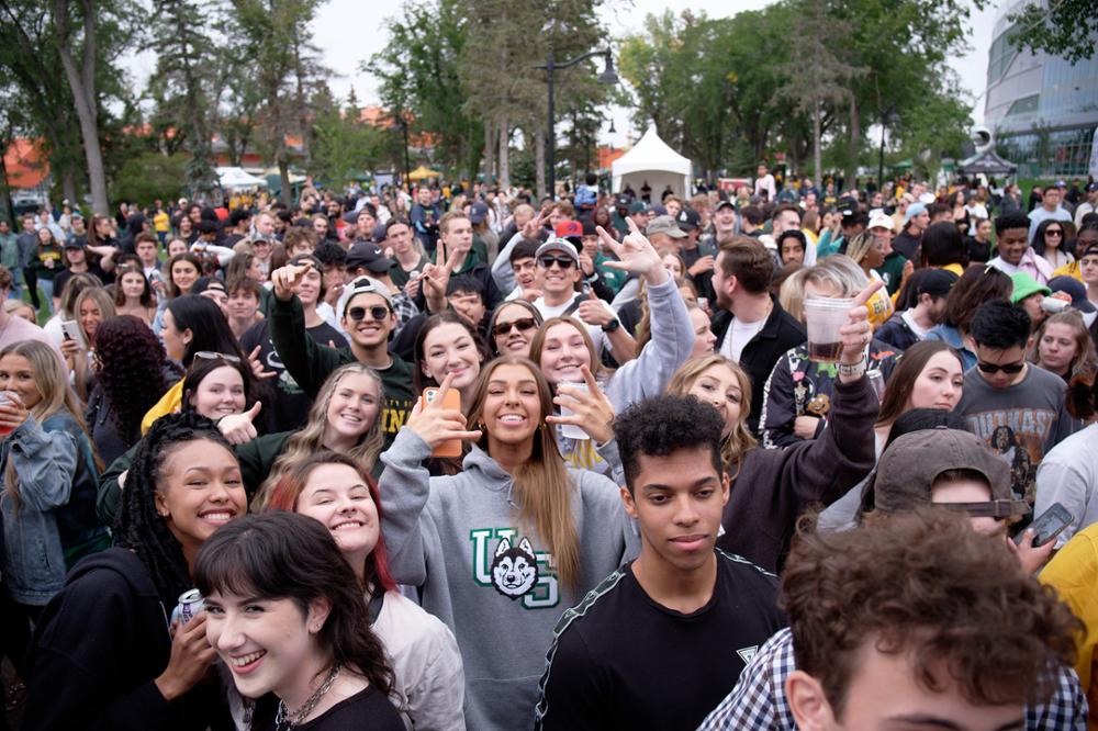 Large group of fans at tailgate party.