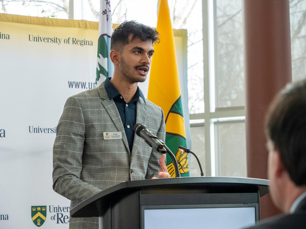 Student speaking at a podium.