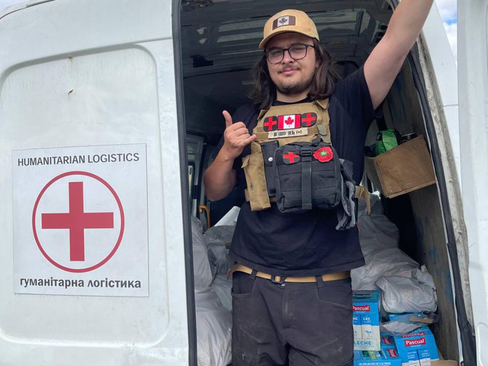 Man posing inside of a humanitarian rescue vehicle.