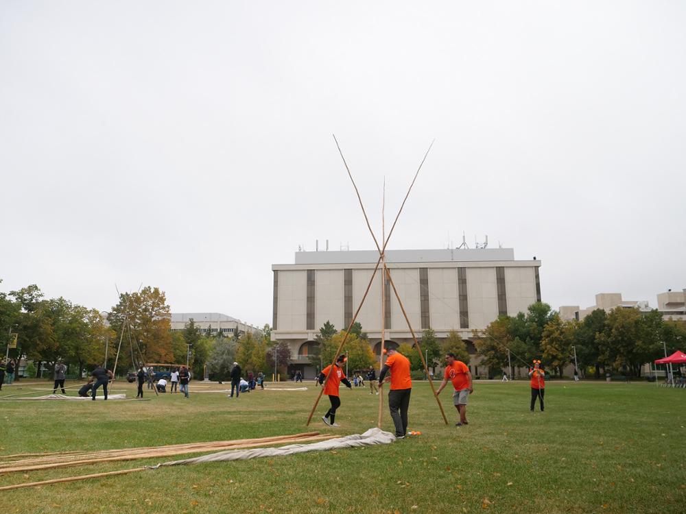 Third pole added and poles spread to form tipi structure. Credit: University Advancement and Communications.