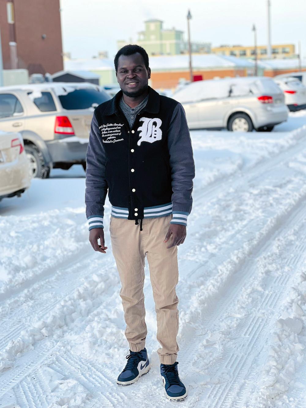 A student posing outside on a winter day in downtown Regina.