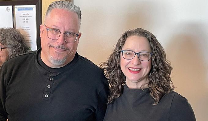 A man and a woman pose for the camera.