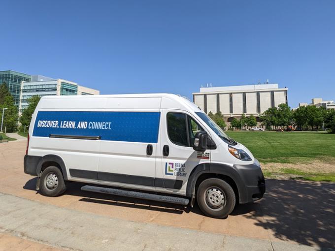 library delivery truck parked outside in front of library