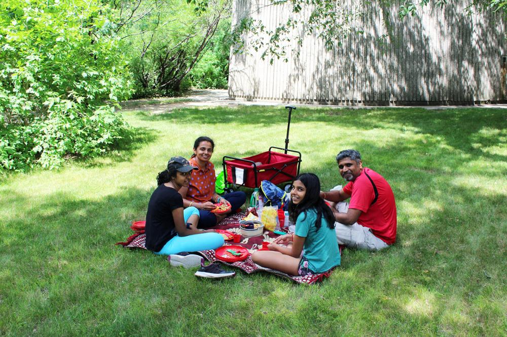 A family having a picnic on a blanket