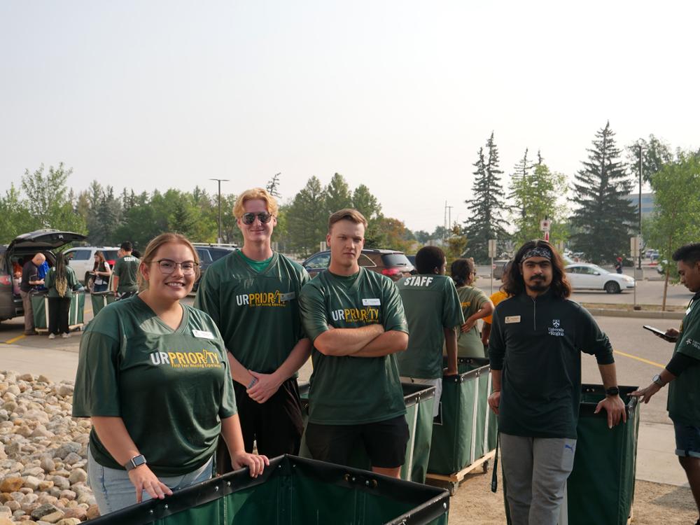 Four students posing for the camera on move-in day.