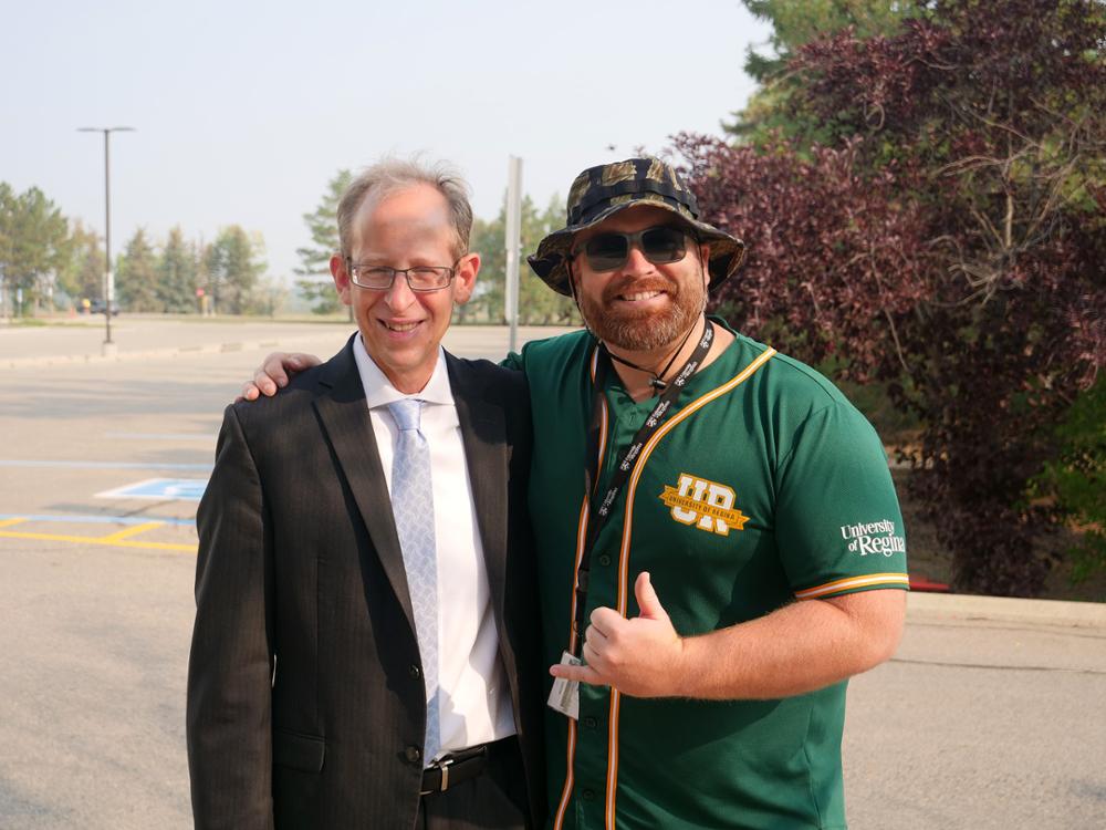 The president and a student pose for a photo