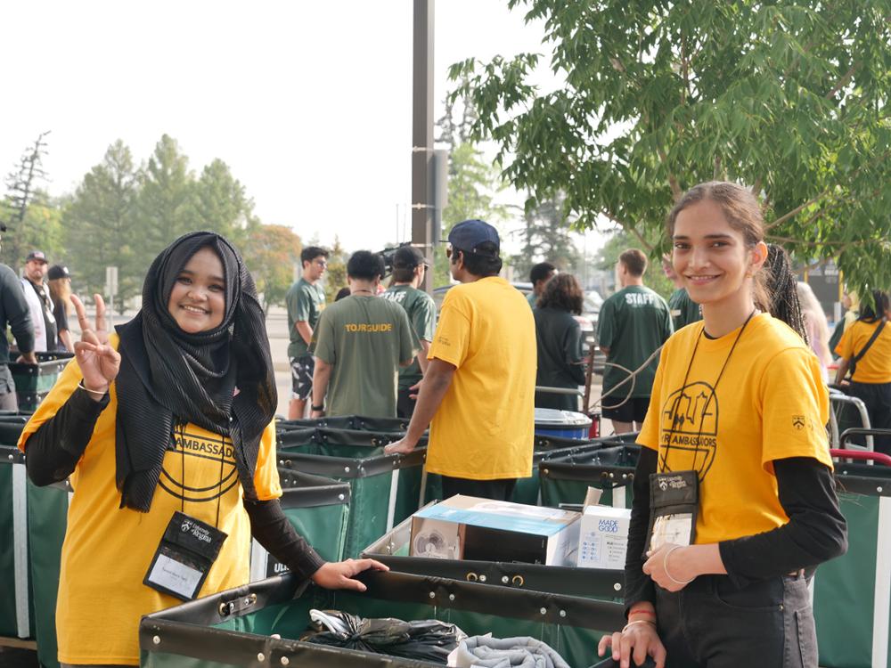 Two students pose for the camera on move-in day.
