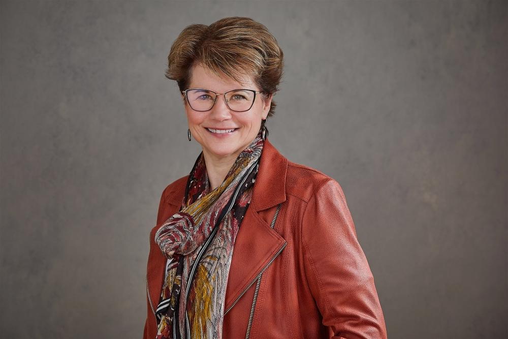 A smiling woman wearing glasses