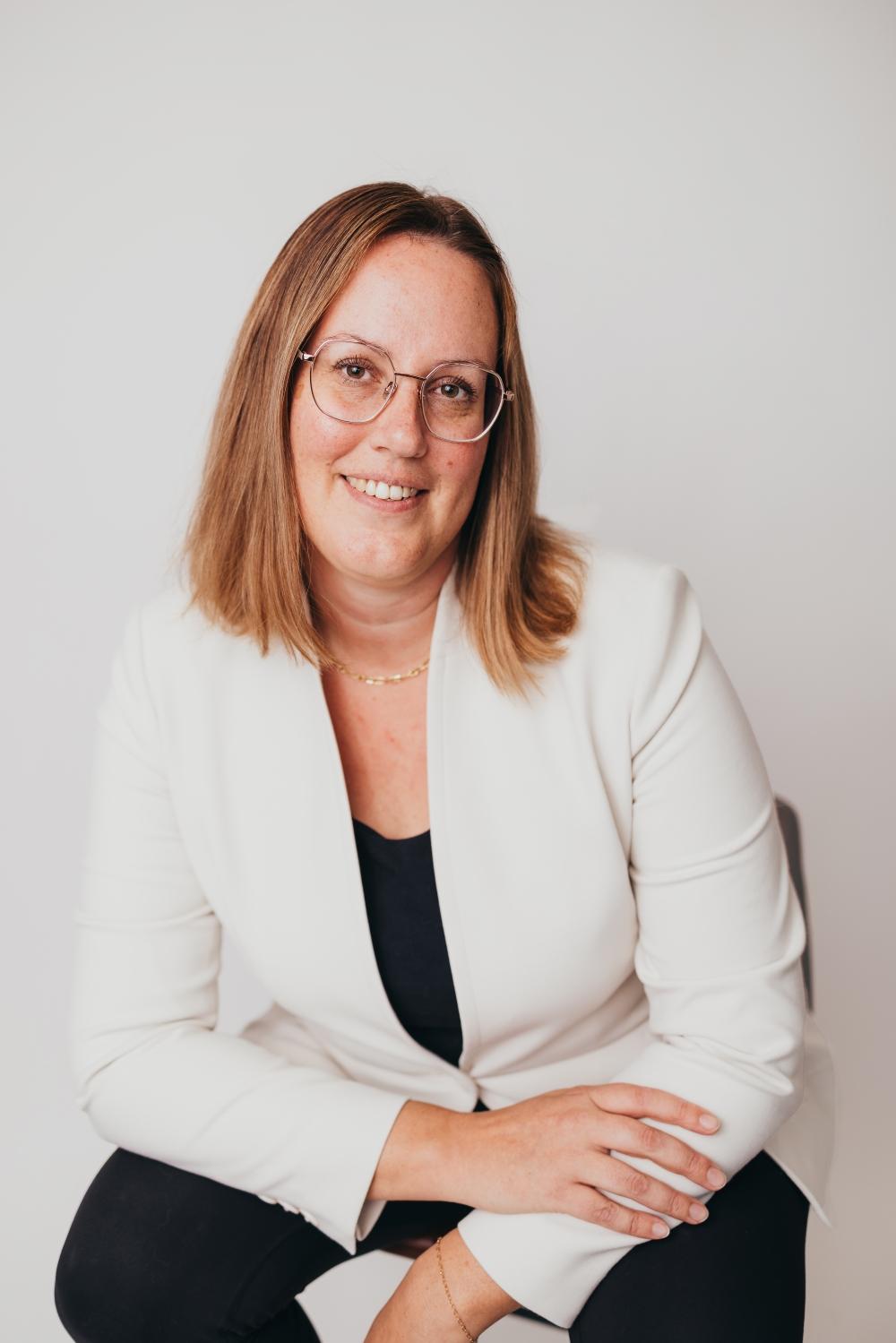 A smiling woman wearing glasses