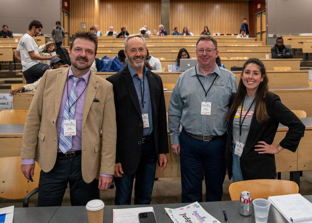 Four judges of the Innovation Challenge smile for photo during the break at the closing event.