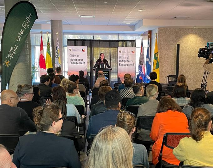 A person at a podium in front of an audience