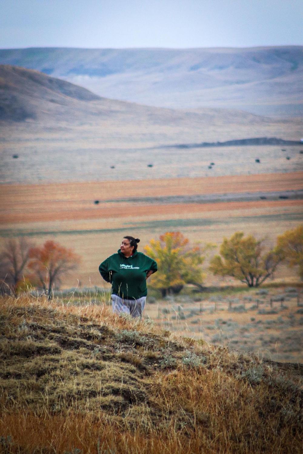 A professor standing in a prairie field