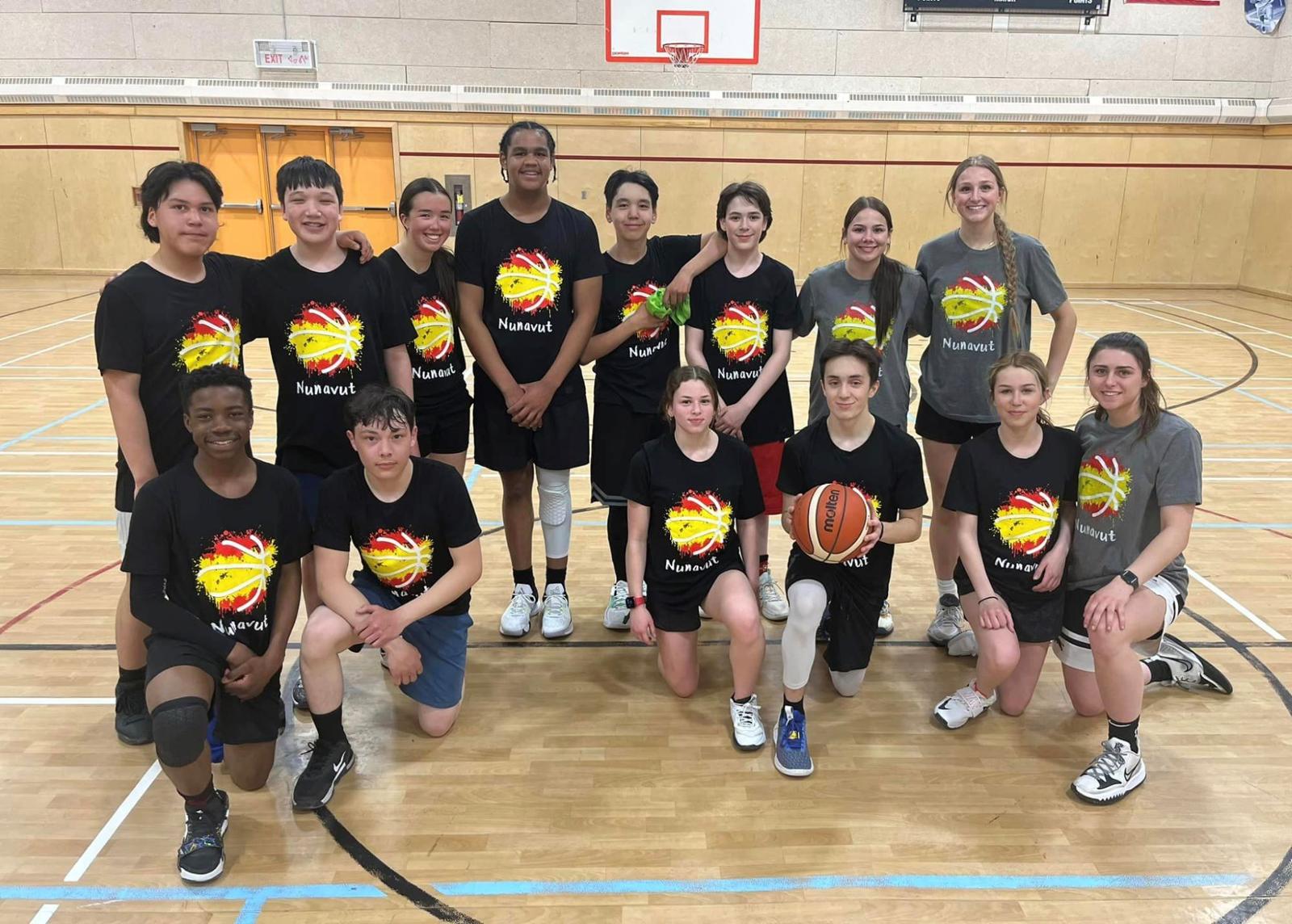 A group of kids and adults in a gym.