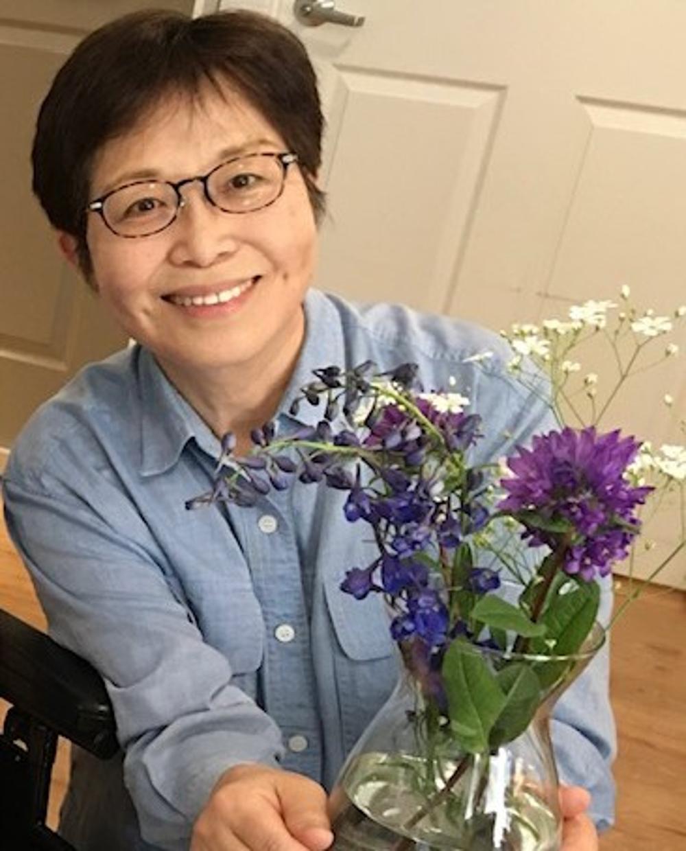 Woman holding a vase of flowers