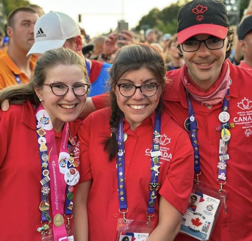 Three teammates wearing medals