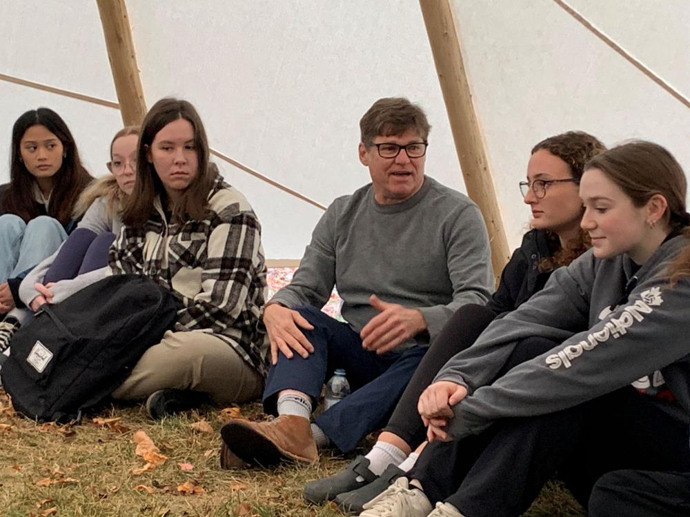 A professor and students in a tipi