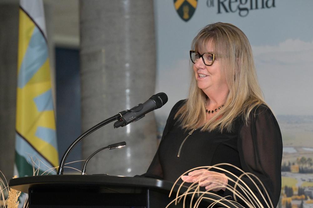 Individual speaking at a podium.