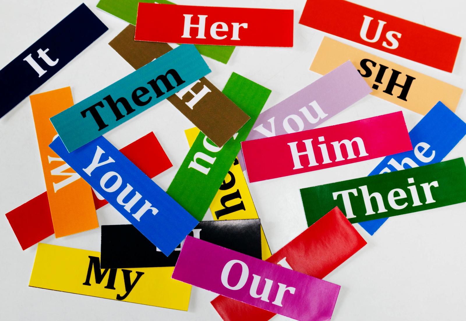 Collection of pronouns on colored pieces of paper.