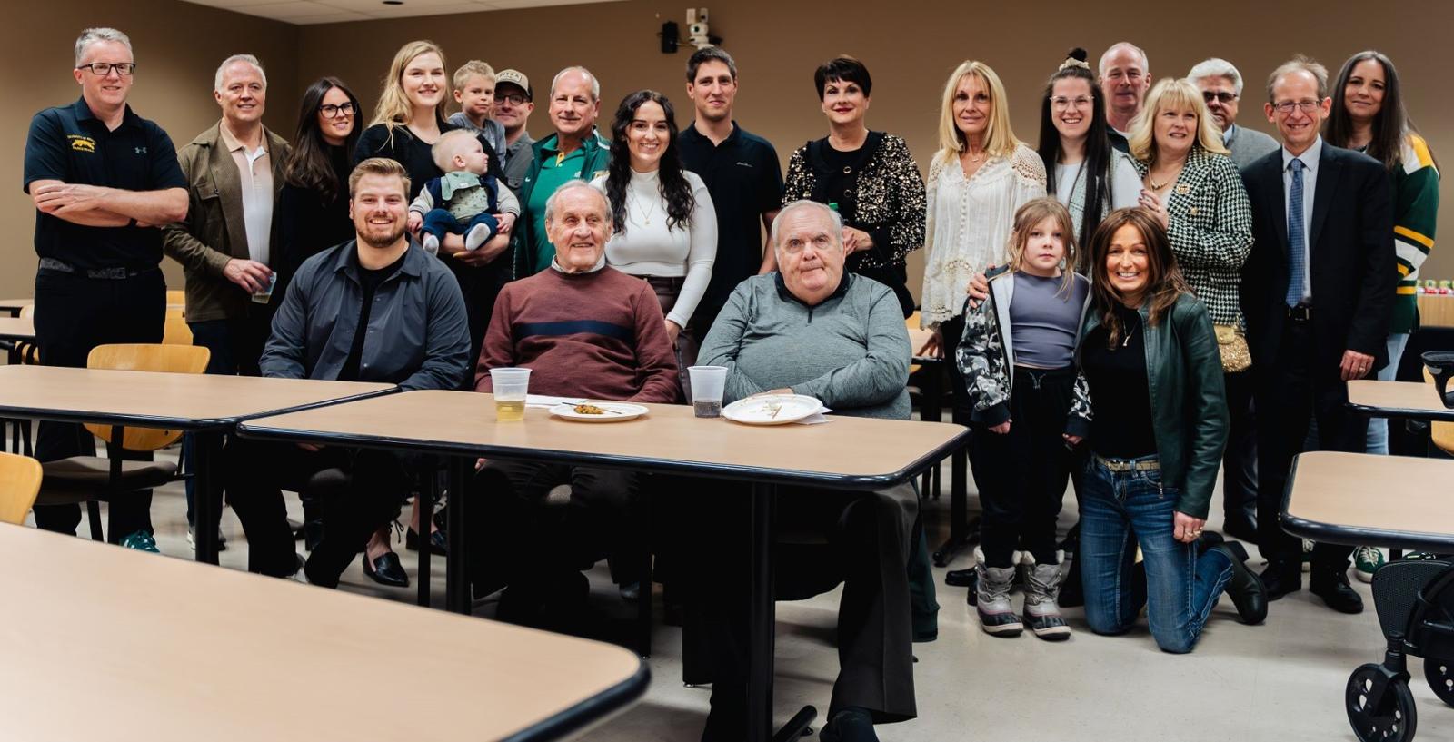 a group of about twenty people pose for a photo