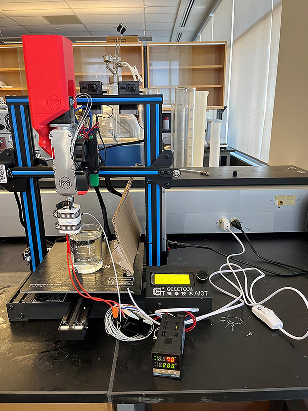A 3D printer and equipment sits on a counter in a classroom