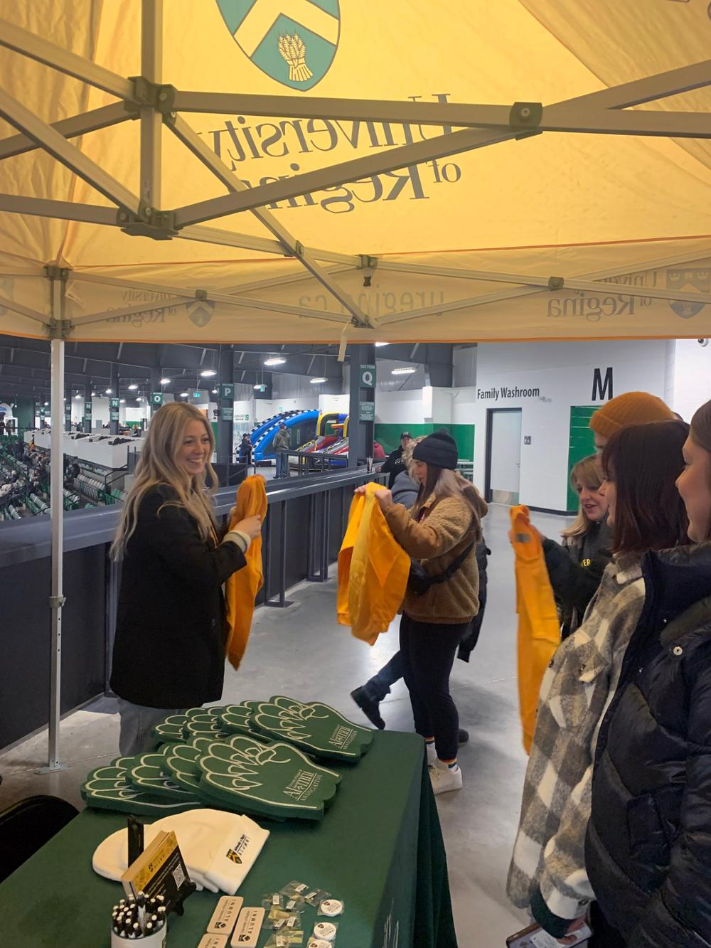 People getting free sweatshirts at the game