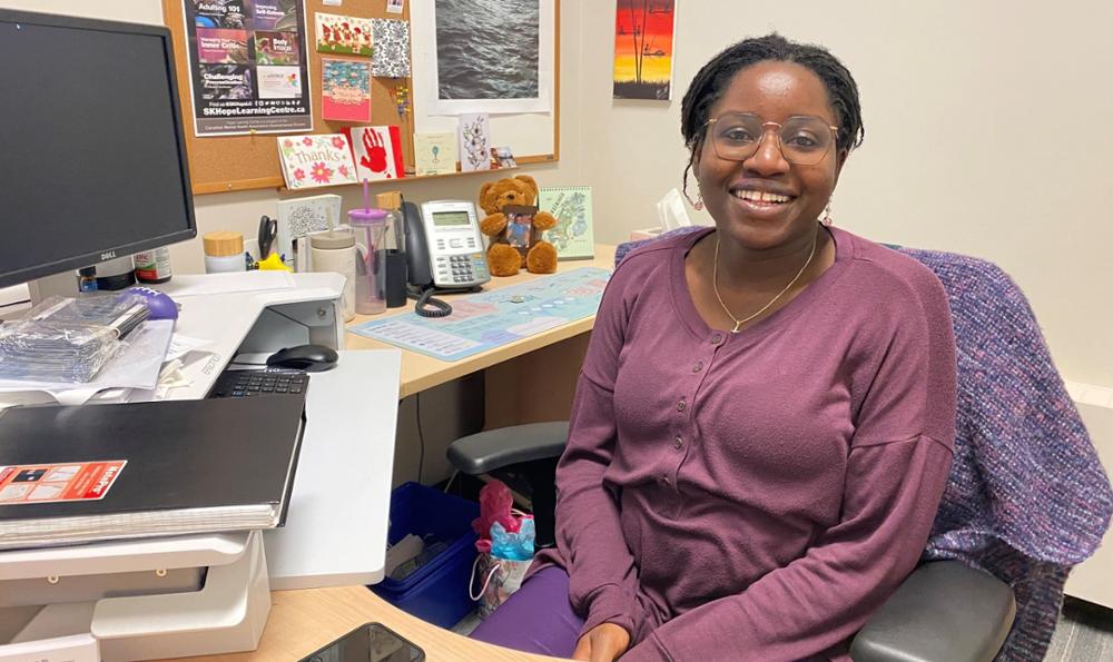 Advisor seated in her office at her desk.