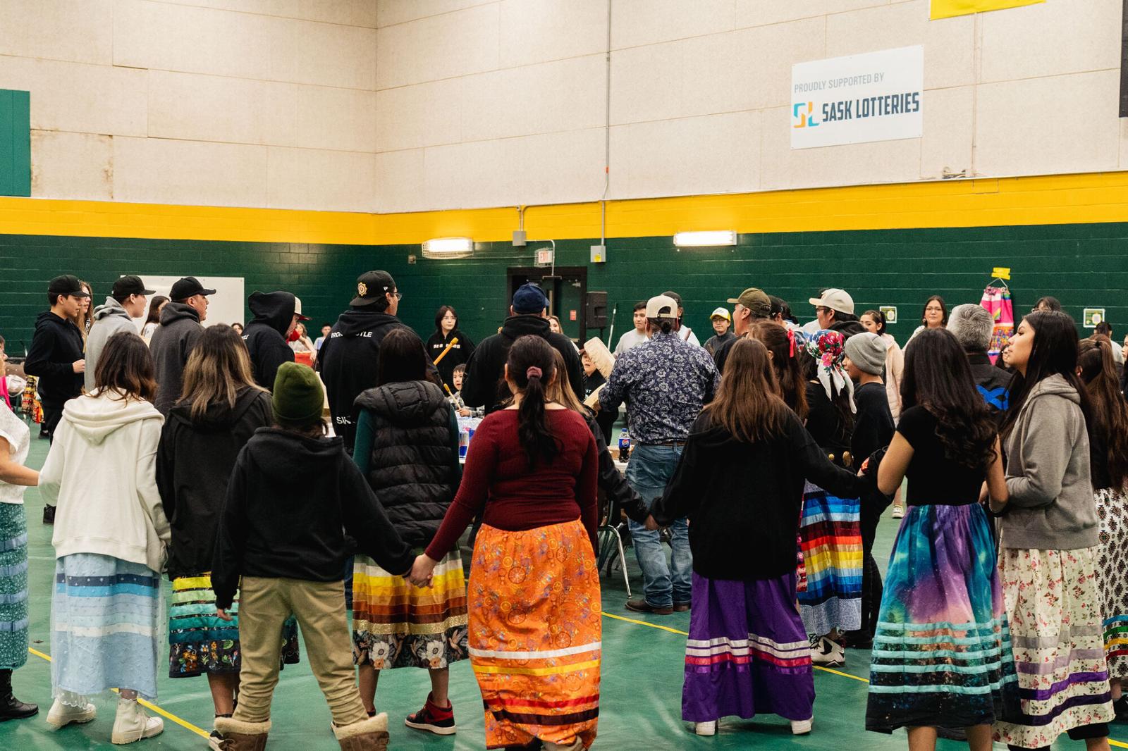 A round dance of people holding hands