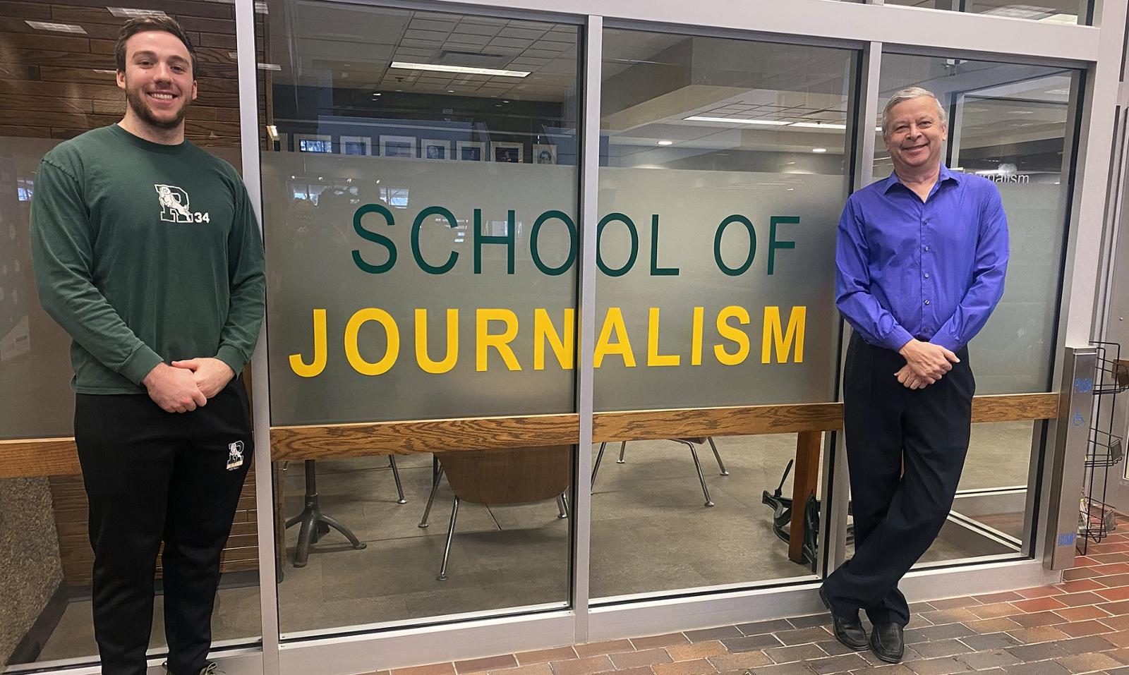 Two men standing at the entrance to the U of R School of Journalism