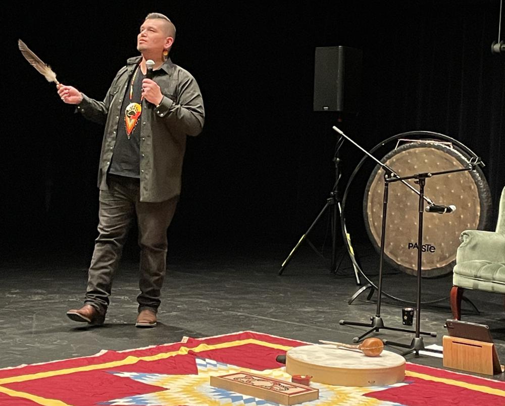 An individual on a stage putting on a presentation.