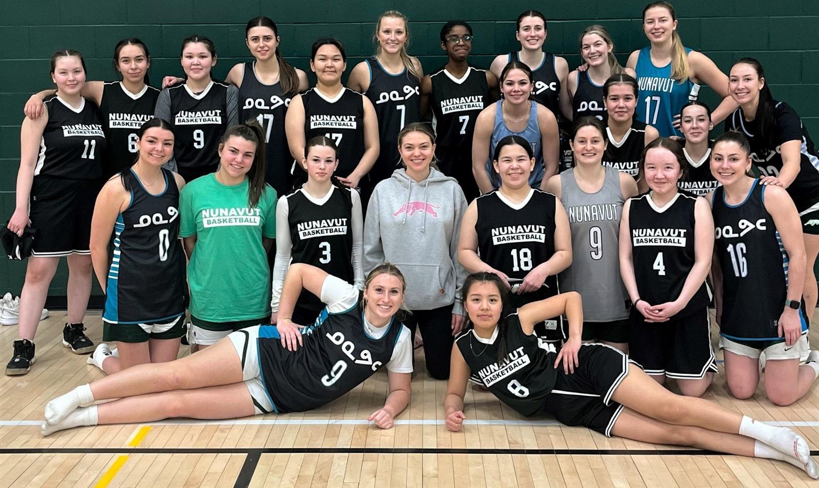 A women's basketball team posing for a team picture