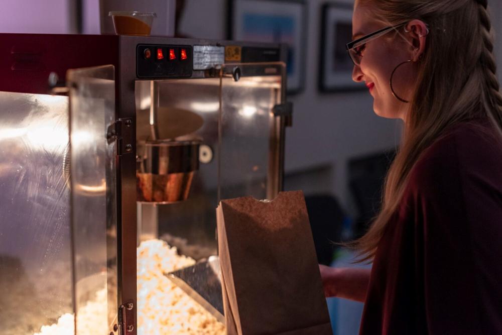 a person tending to a large popcorn machine