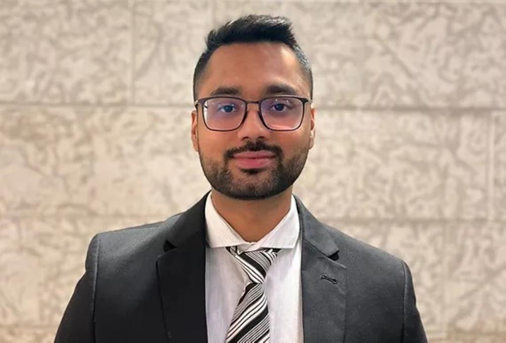 Headshot of young man in business suit.