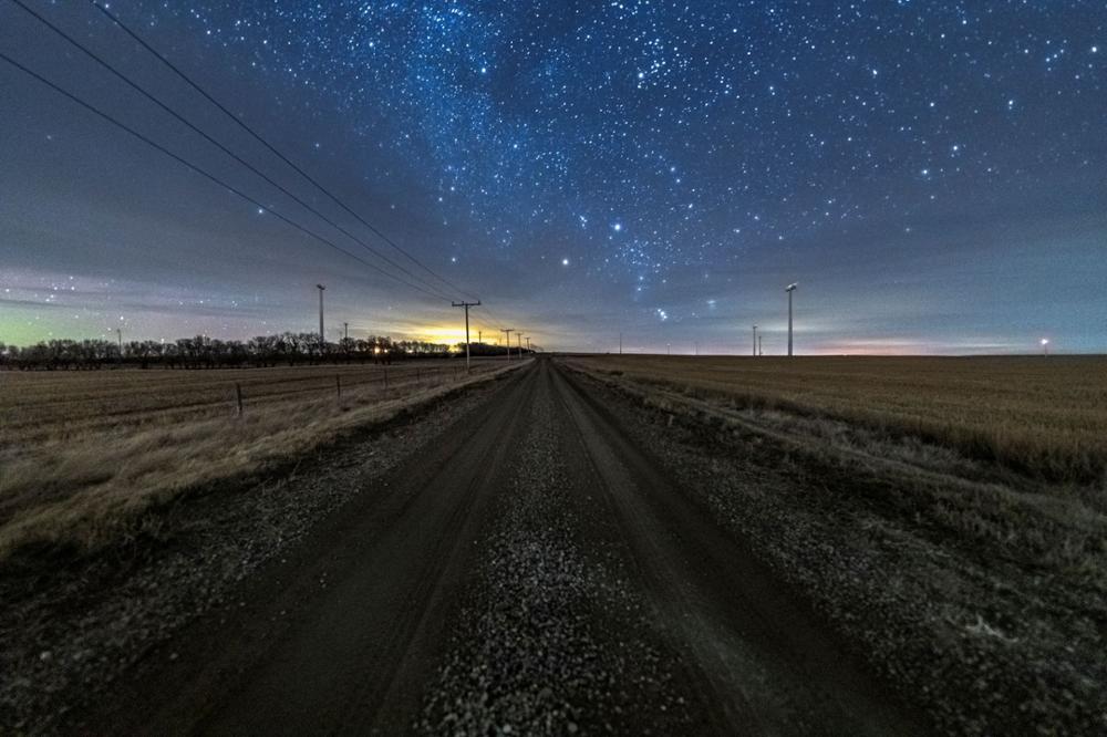 stars over the horizon in a night sky