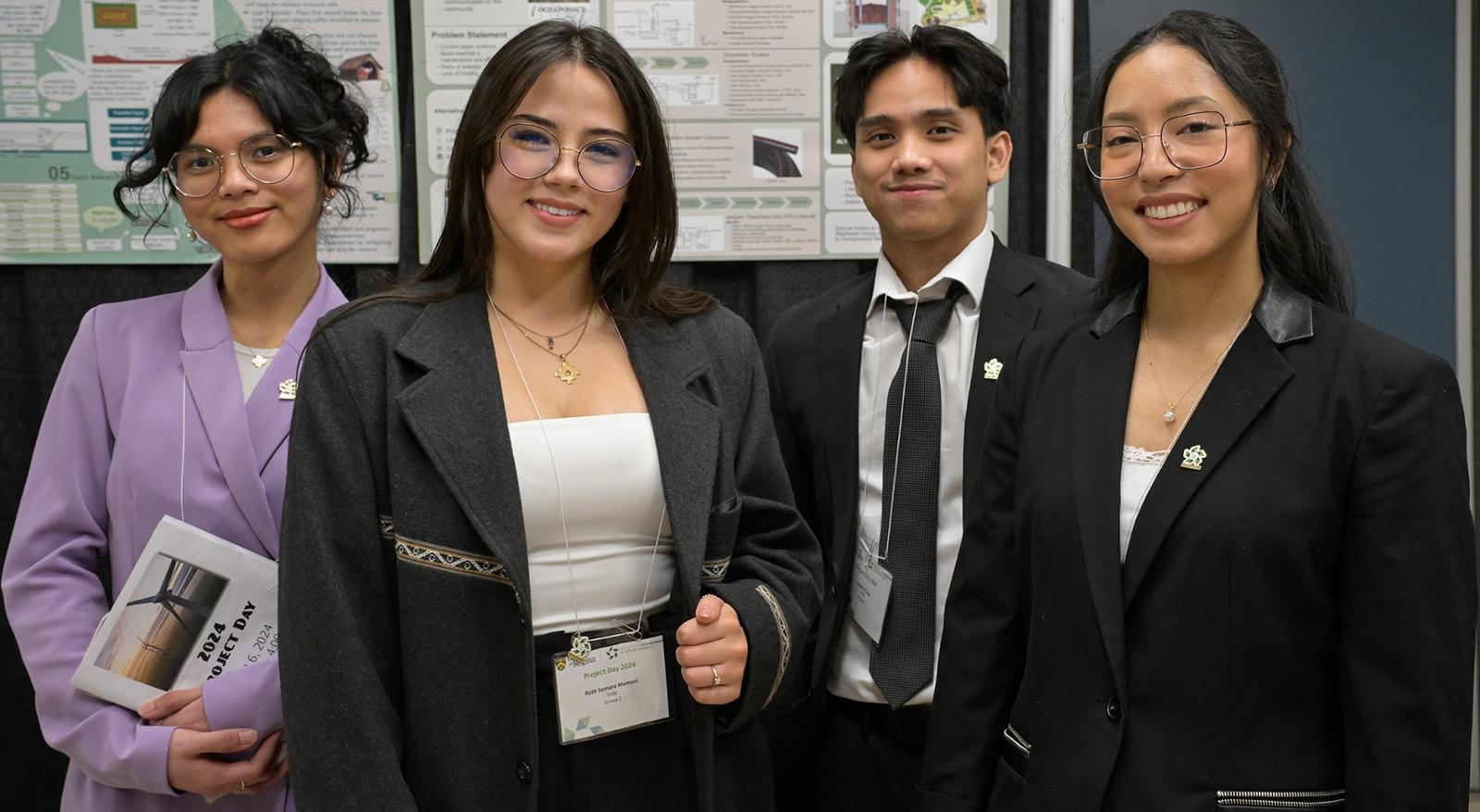 A group of individuals stands in front of a project board.