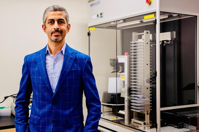 Man standing beside lab equipment