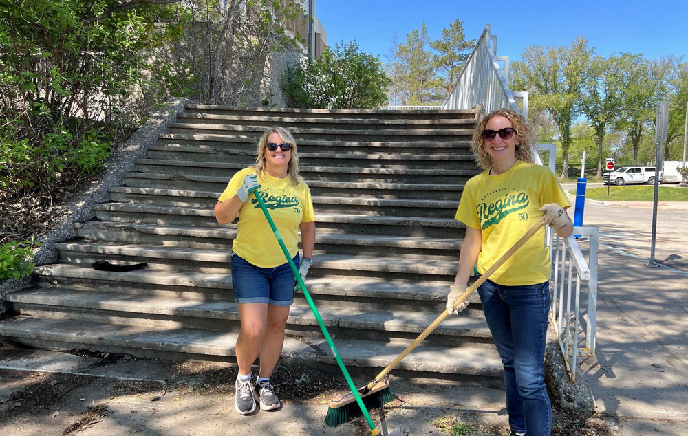 two people raking
