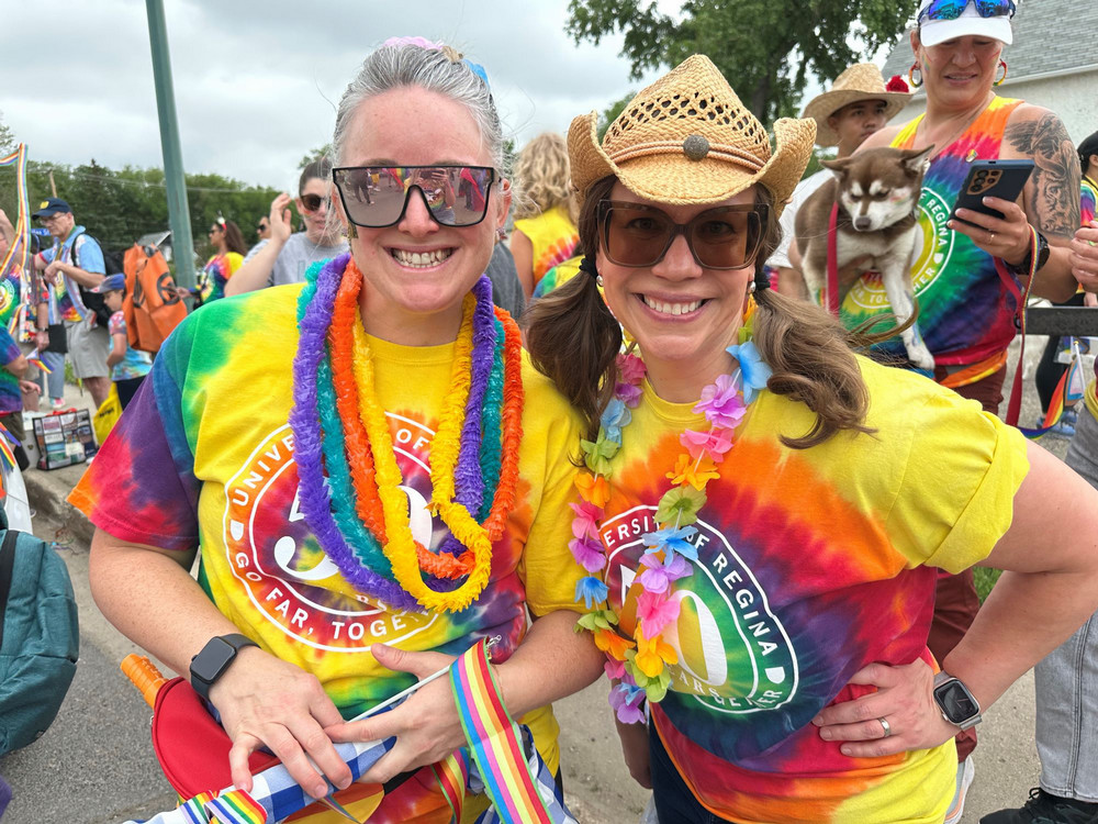 Two people wearing colourful shirts in a parade