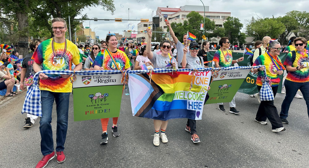 a group of people carrying a banner in a parade