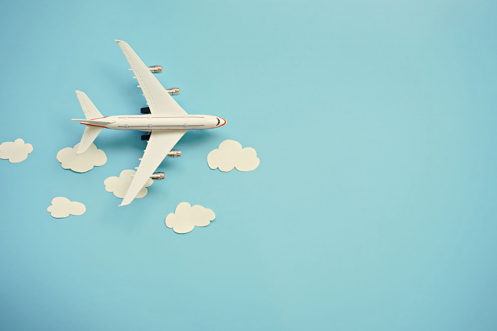A plane with clouds on a blue background