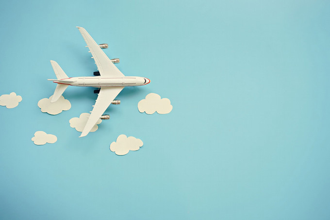 A plane with clouds on a blue background